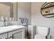 Modern bathroom features a gray vanity and a toilet with modern decor at 17138 Joliet Rd, Westfield, IN 46074