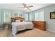 Cozy bedroom with light blue walls, a ceiling fan, and hardwood furniture at 17138 Joliet Rd, Westfield, IN 46074