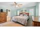 Inviting bedroom with a ceiling fan, soothing paint color and light-filled windows and wood furnishings at 17138 Joliet Rd, Westfield, IN 46074