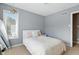 Cozy bedroom featuring a window, a plant hanging from the ceiling, neutral decor and plush bedding at 17138 Joliet Rd, Westfield, IN 46074