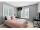 Comfortable bedroom with a mounted TV, natural light from windows, and a neutral color scheme at 17138 Joliet Rd, Westfield, IN 46074