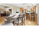 A view of the dining room with wood table and chair set next to an open kitchen with wood cabinets at 17138 Joliet Rd, Westfield, IN 46074