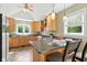 Light-filled kitchen with wood cabinets and a stylish breakfast bar area at 17138 Joliet Rd, Westfield, IN 46074