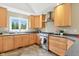 Bright kitchen with stainless steel appliances, stone countertops, and wood cabinets at 17138 Joliet Rd, Westfield, IN 46074