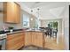 Open kitchen with light wood cabinetry, stainless steel appliances, and eat-in breakfast bar at 17138 Joliet Rd, Westfield, IN 46074