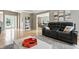 Cozy living room with hardwood floors, a gray couch, and an open view into the dining area at 17138 Joliet Rd, Westfield, IN 46074
