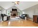A well-lit living room features a brick fireplace, TV, hardwood floors, and plush seating at 17138 Joliet Rd, Westfield, IN 46074