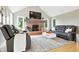 A well-lit living room features a brick fireplace, vaulted ceilings, hardwood floors, and plush seating at 17138 Joliet Rd, Westfield, IN 46074