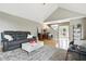 Hardwood living room with vaulted ceilings, gray walls, nice couch, and access to a staircase and front door at 17138 Joliet Rd, Westfield, IN 46074