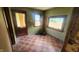 Empty dining area with tiled floors, a door, and large windows at 2157 Sugar Grove Ave, Indianapolis, IN 46202