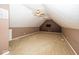 Finished attic space with neutral carpeting, a ceiling fan, and a wall-mounted TV at 2325 N Talbott St, Indianapolis, IN 46205