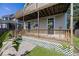 Inviting back porch featuring a wooden deck, decorative lattice, and colorful hanging plants at 2325 N Talbott St, Indianapolis, IN 46205