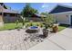 Beautiful backyard with a blue-stoned fire pit, various potted plants, and green lawn at 2325 N Talbott St, Indianapolis, IN 46205