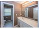 Well-lit bathroom featuring a large mirror, white vanity, and a separate toilet and shower area at 2325 N Talbott St, Indianapolis, IN 46205