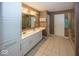 A well-lit bathroom featuring double sinks, a large mirror, and tiled flooring at 2325 N Talbott St, Indianapolis, IN 46205
