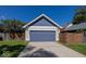 Detached two-car garage with a blue door, siding, and a paved driveway at 2325 N Talbott St, Indianapolis, IN 46205