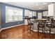 Modern kitchen featuring white cabinets, black countertops, stainless steel appliances, and bar seating for casual dining at 2325 N Talbott St, Indianapolis, IN 46205