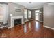 Cozy living room boasts a fireplace, hardwood floors, and multiple windows for a bright and inviting atmosphere at 2325 N Talbott St, Indianapolis, IN 46205