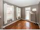 Bright living area with wood floors, a floor lamp, and natural light from large windows and glass patio door at 2325 N Talbott St, Indianapolis, IN 46205