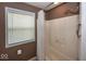 Shower stall with a shower curtain, toiletry storage, and a window for natural light at 2325 N Talbott St, Indianapolis, IN 46205