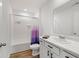 Well-lit bathroom featuring a white vanity with marble countertops and a tub with a purple shower curtain at 24416 Kercheval St, Sheridan, IN 46069
