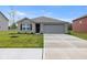 Charming single-story home with a well-manicured lawn and a spacious two-car garage at 24416 Kercheval St, Sheridan, IN 46069