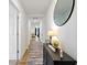 Bright hallway with a decorative table and a rug leading to a living area at 24416 Kercheval St, Sheridan, IN 46069