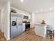 Well-lit kitchen with white cabinets, stainless steel appliances, a kitchen island, and barstool seating at 24416 Kercheval St, Sheridan, IN 46069