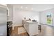 Bright kitchen with white cabinets, a center island with an eat-in bar, and stainless appliances at 24416 Kercheval St, Sheridan, IN 46069