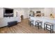 Open concept living room and kitchen featuring an accent wall, bar seating, and hardwood floors at 24416 Kercheval St, Sheridan, IN 46069