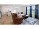 Bright living room featuring neutral paint, wood-look floors, modern sofa, and a blue accent rug at 24416 Kercheval St, Sheridan, IN 46069