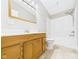 Bathroom featuring a wooden vanity, tile floors, a shower-tub combo, and great lighting at 2895 E 600 S, Markleville, IN 46056