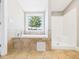 Bathroom featuring a soaking tub, walk in shower, and tile surround at 2895 E 600 S, Markleville, IN 46056