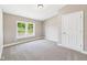 This bedroom features neutral paint, carpet, and a window with a view of the outdoors at 2895 E 600 S, Markleville, IN 46056