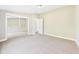 Bedroom features neutral paint, carpet, a closet with mirrored doors, and an adjacent doorway at 2895 E 600 S, Markleville, IN 46056