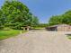 Spacious property with multiple outbuildings, gravel area, and lush green lawn at 2895 E 600 S, Markleville, IN 46056
