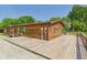 Exterior view of a cabin with a wooden deck and green door, surrounded by trees at 2895 E 600 S, Markleville, IN 46056
