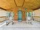 Cozy front porch with rocking chairs, rustic decor, and a welcoming entrance at 2895 E 600 S, Markleville, IN 46056
