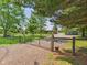Scenic view of a gated property with a long driveway and lush green lawn at 2895 E 600 S, Markleville, IN 46056