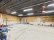 Open garage area with high metal ceiling, shelving, and concrete floor at 2895 E 600 S, Markleville, IN 46056