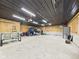 Spacious garage with metal ceiling, work benches and shelving, and room for storage at 2895 E 600 S, Markleville, IN 46056