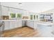 Bright, open kitchen featuring white cabinetry, stainless steel appliances, and hardwood floors at 2895 E 600 S, Markleville, IN 46056