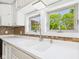 Bright kitchen featuring stone countertops, tiled backsplash, and a double bowl sink at 2895 E 600 S, Markleville, IN 46056