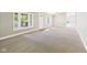 Spacious living room with large windows letting in natural light and neutral carpeting and paint at 2895 E 600 S, Markleville, IN 46056