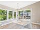 Bright room with hardwood floors, large windows, and sliding glass doors leading to the deck at 2895 E 600 S, Markleville, IN 46056