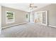 Spacious primary bedroom with neutral carpeting, ceiling fan, and ensuite bathroom access at 2895 E 600 S, Markleville, IN 46056