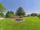 Expansive grassy yard with fire pit, mature trees, and charming wooden home at 2895 E 600 S, Markleville, IN 46056