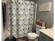 Well-lit bathroom featuring a patterned shower curtain, a basket of towels, and modern fixtures at 2925 Morgan Trl, Martinsville, IN 46151