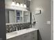 Bathroom featuring a dual sink vanity with marble countertops, and gray backsplash at 2925 Morgan Trl, Martinsville, IN 46151