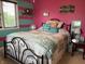 Vibrant bedroom featuring a queen-sized bed, striped walls, and ample natural light from the window at 2925 Morgan Trl, Martinsville, IN 46151